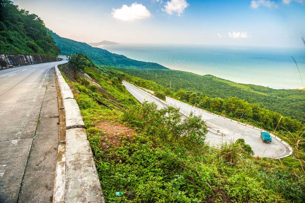 Multiple Hairpin Turns on Hai Van Pass – A stunning panoramic view showcasing several sharp hairpin bends along the Hai Van Pass, cutting through the misty mountains.