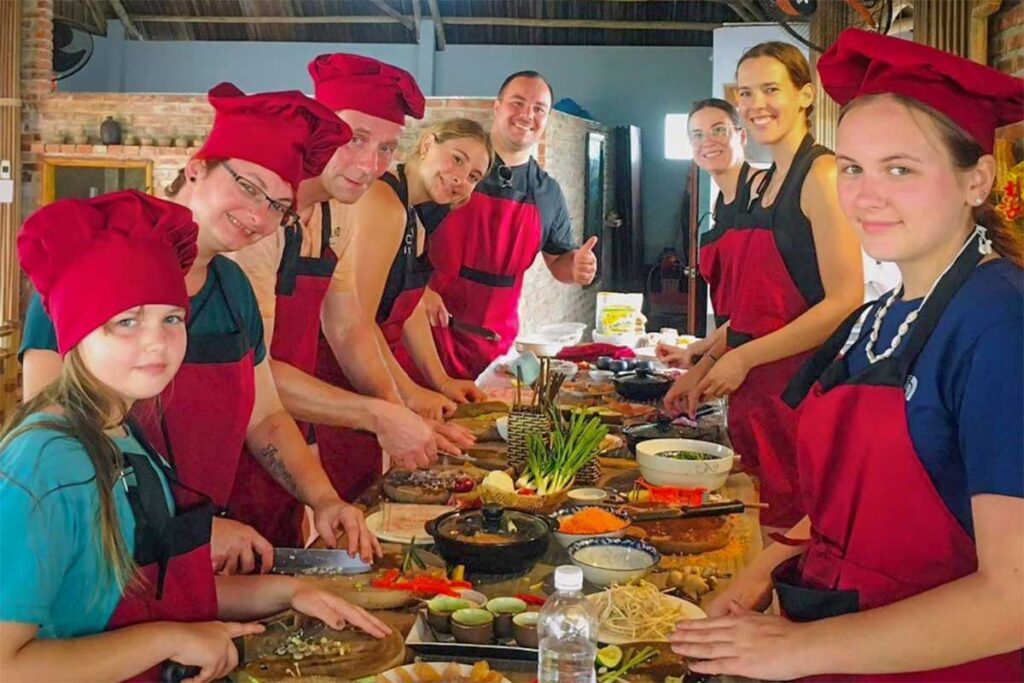 Family preparing Vietnamese dishes at Hoi An Tropical Cooking Tour