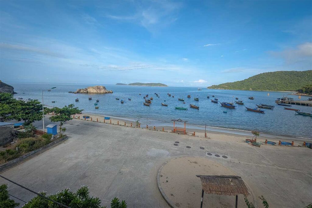 Boats anchored at Bai Lang central beach on Cham Island, the island’s main harbor and heart of local fishing life.
