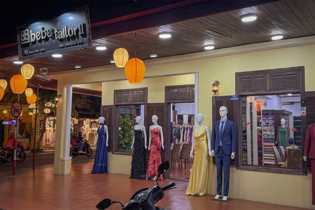 Elegant dresses and suits on display at Bebe Tailor, highlighting Hoi An’s reputation for quality tailor made and custom clothing.