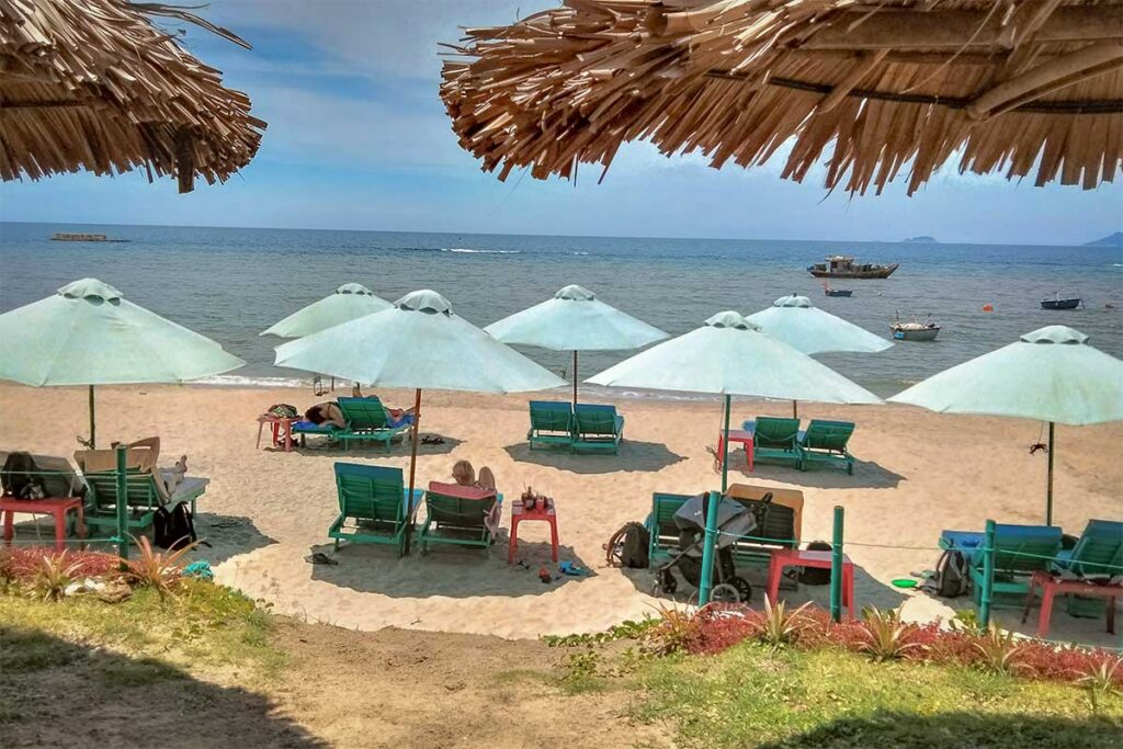 Coconut Beach Hoi An with rows of white umbrellas and turquoise sea views, ideal for relaxing by the water