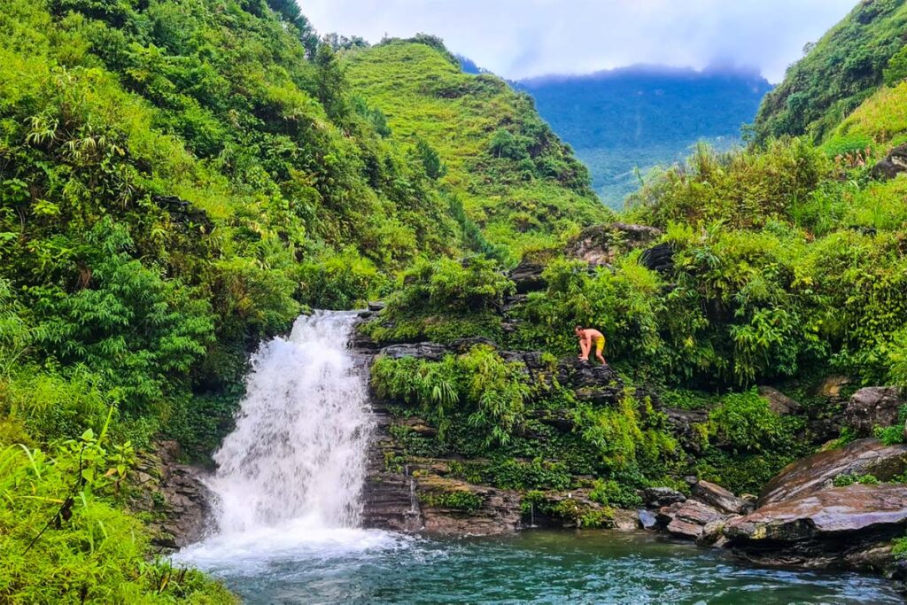 A tourist jumping from the Du Gia Waterfall in Ha Giang