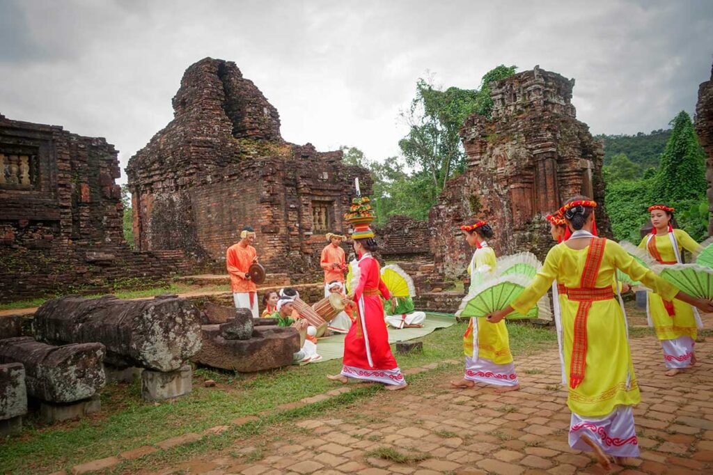 Cham dance performance among the ruins of My Son Sanctuary, featuring traditional costumes and live drumming after morning tours.