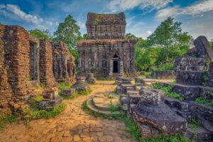 Main temple tower group at My Son Sanctuary with red-brick Cham architecture and mountain backdrop in central Vietnam.