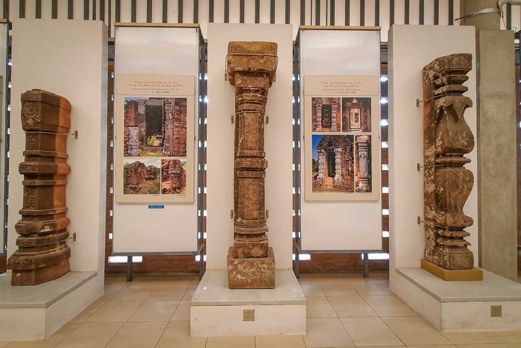 Interior of My Son Sanctuary museum displaying original Cham stone carvings and architectural fragments found on site.