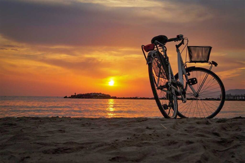 Bicycle parked on the sandy coast of Tam Hai Island during a sunset ride, highlighting the island’s relaxed and scenic atmosphere.