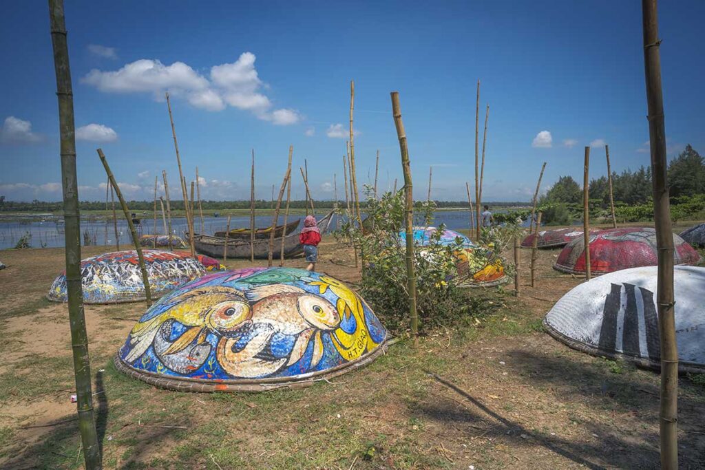 Colorful painted basket boats at Tam Thanh Mural Village, Vietnam’s first mural village, where local art meets the peaceful seaside near Tam Ky.