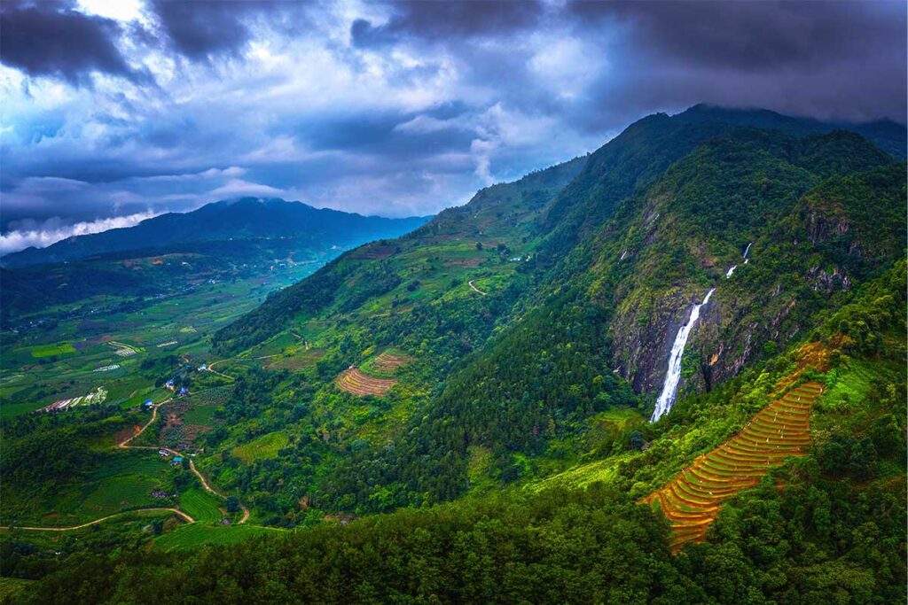 arial photo of Tac Tinh Waterfall with mountains and rice fields