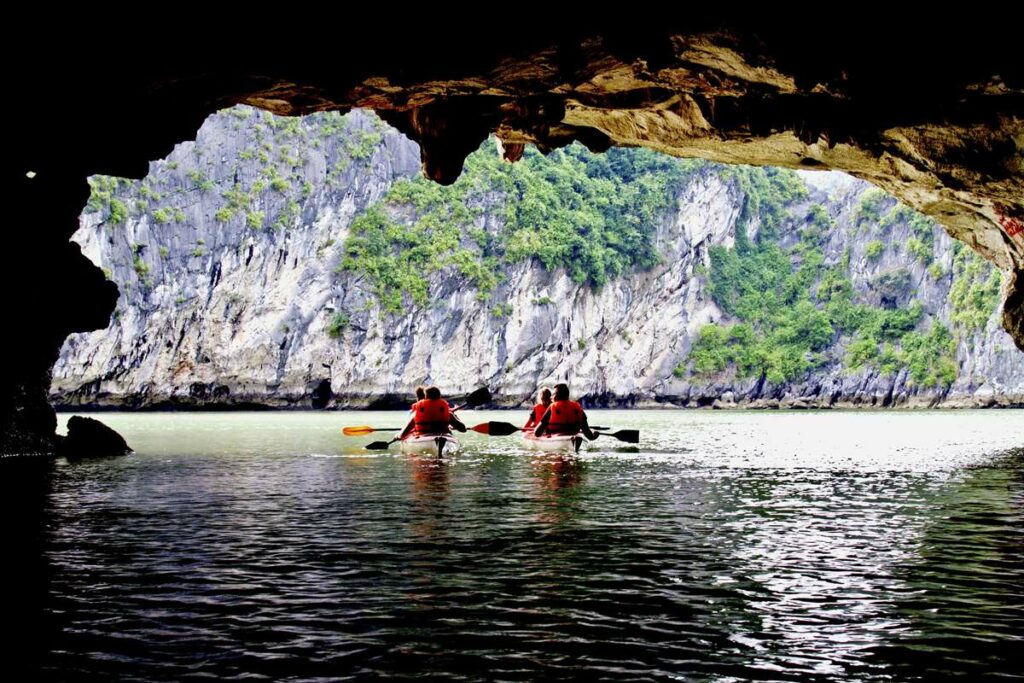 kayaking through a cave in Halong Bay