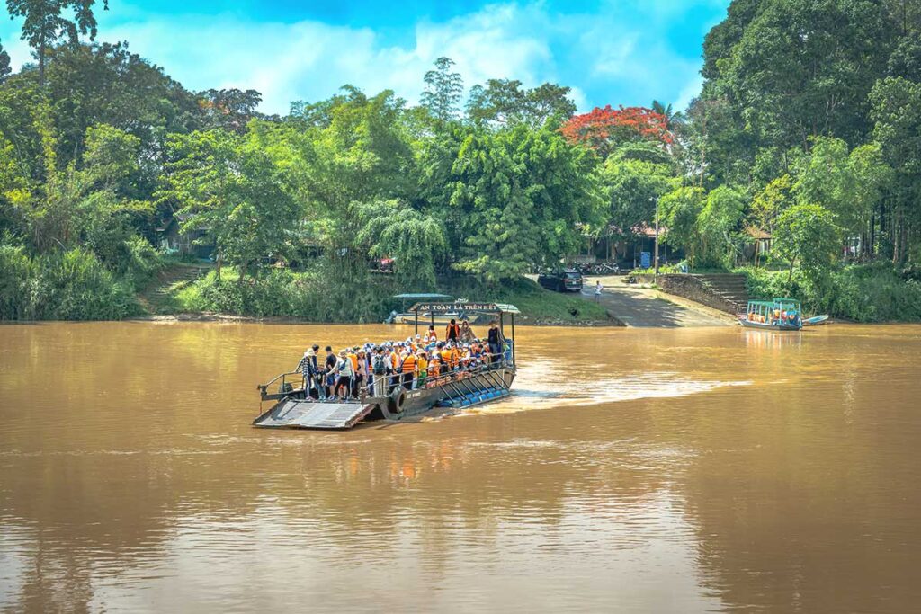 A ferry packed with tourists crossing the Dong Nai River, the main entrance to Cat Tien National Park.