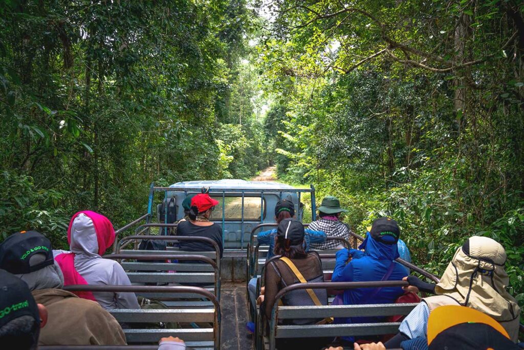 An open jeep driving along a forest path, offering visitors a guided wildlife tour through Cat Tien National Park.