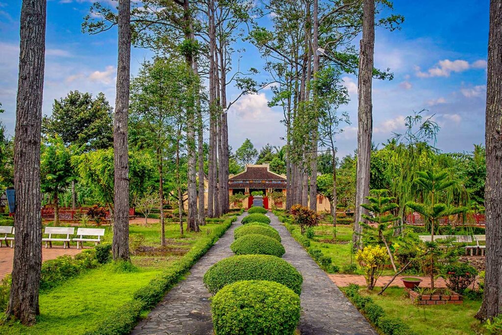 Van Thanh Mieu Temple in Vinh Long – The 19th-century Confucian temple with a scenic garden path lined by tall trees, a cultural highlight of Vinh Long, Mekong Delta.