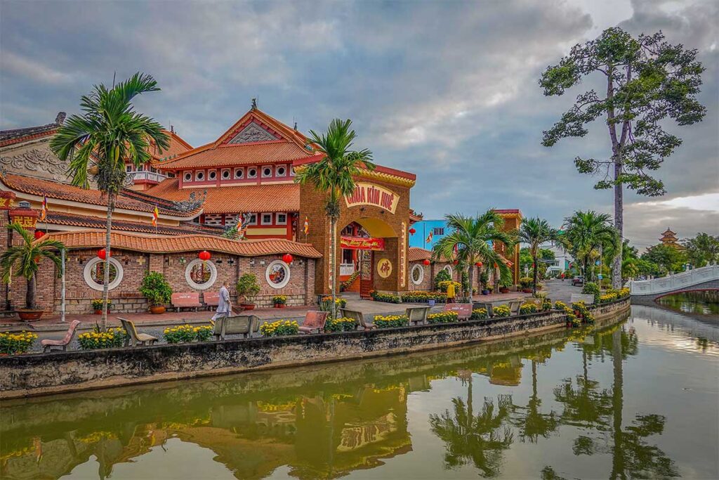Kim Hue Pagoda in Sa Dec, Vietnam, a historic Buddhist temple with Chinese architectural influences set beside a quiet canal.