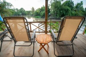 Two deck chairs facing a small canal at a local Can Tho homestay