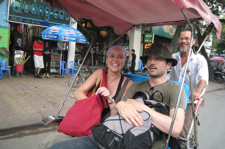 tourist riding a cyclo in Hanoi Old Quarter Vietnam