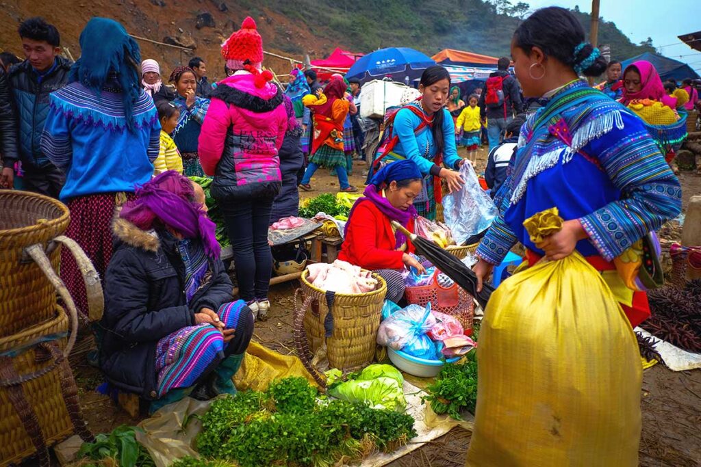 colorful minority woman shopping food at the Can Cau Market