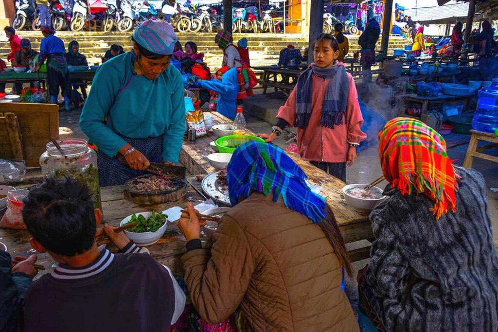 food court at the Can Cau Market with ethnic minority people eating 