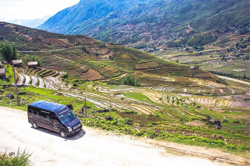 A 16-seater van parked at rice fields of Sapa