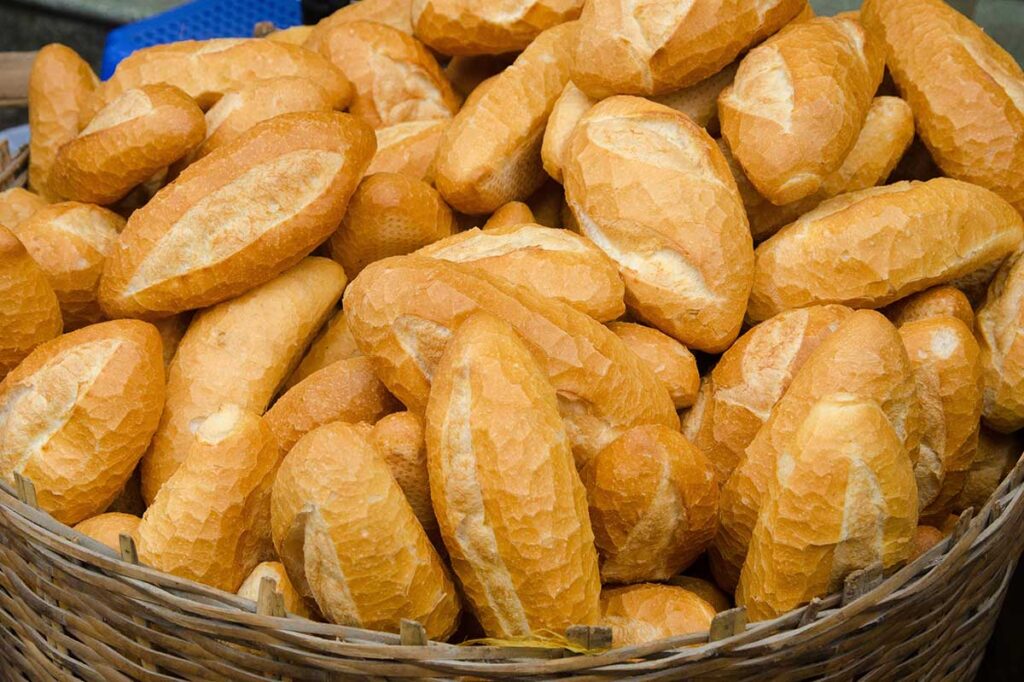 Basket full of Banh Mi, traditional Vietnamese baguettes containing gluten.