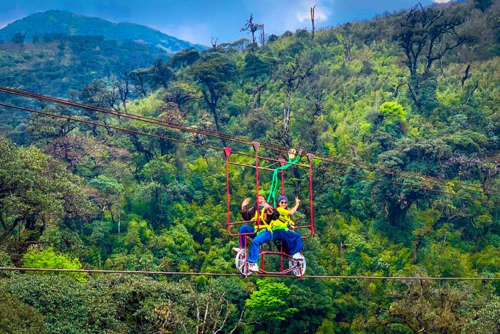 Two people cycling over a rope at Cau Kinh Rong May amusement park