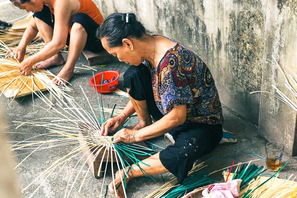 woman crafting a hand fan at Chang Son Village