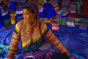 ethnic woman selling brocades at the Coc Ly Market