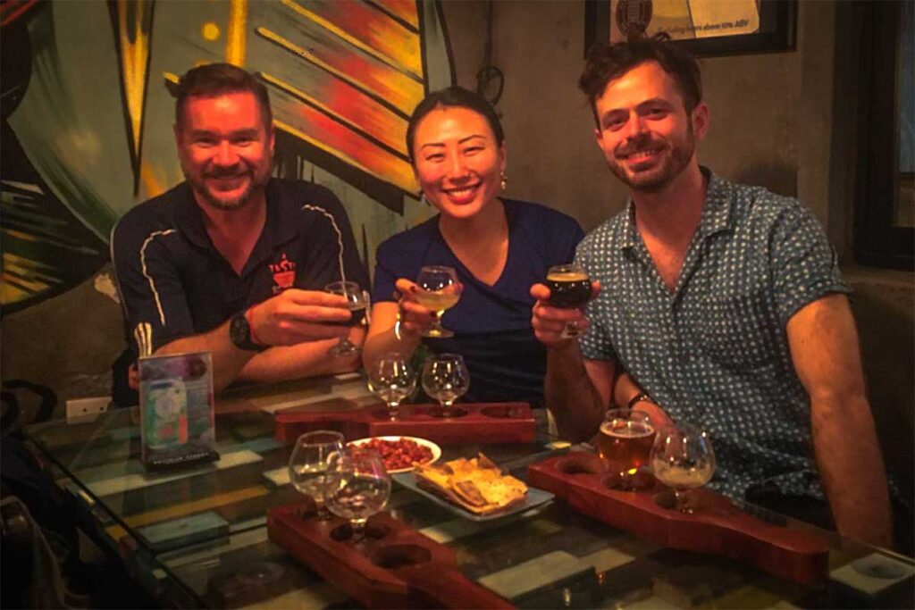 Hanoi Craft Beer Tour: Tourists enjoy a craft beer tasting experience in Hanoi, sampling local brews and learning about Vietnam's emerging craft beer scene.