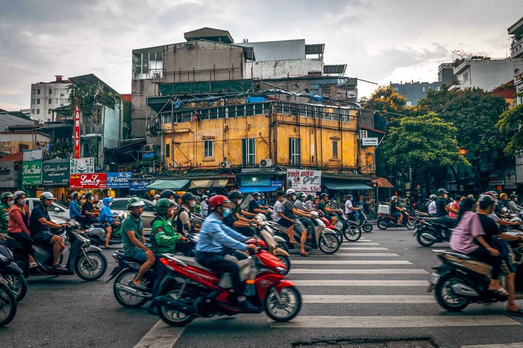 Pedestrian crossing in Hanoi, Vietnam, completely filled with motorbikes driving through