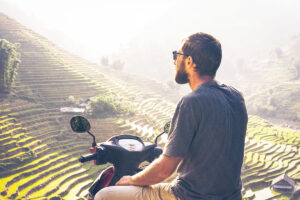 tourist driving motorbike in Sapa with rice fields on the background