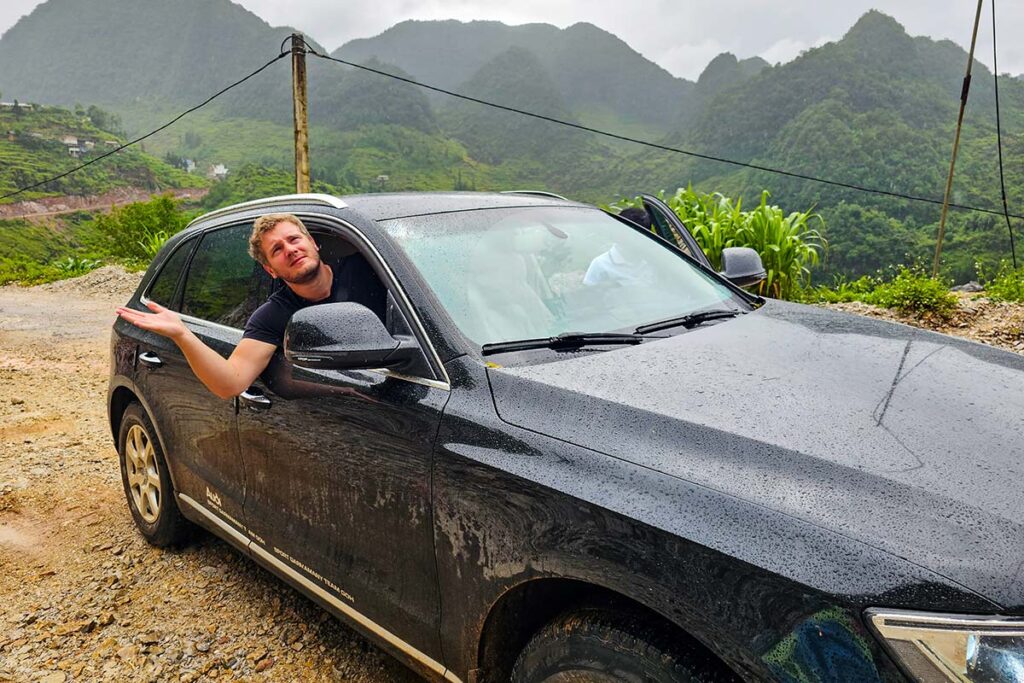 Tourist doing the Ha Giang Loop by car in rainy weather