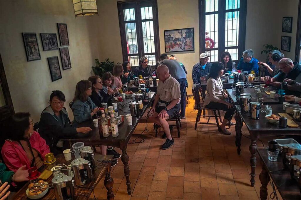 Tourist joining a coffee workshop in Hanoi, where they are learning how to make Vietnamese coffee