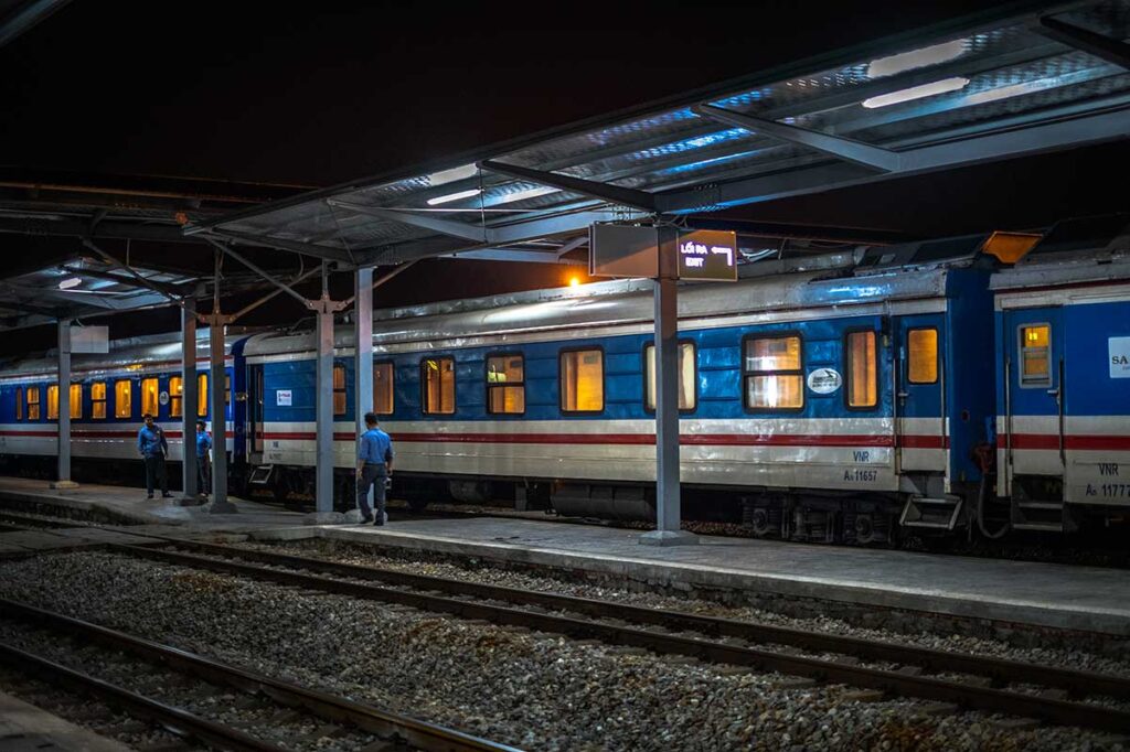 Sleeper train to Sapa at Entrance B of Hanoi Railway Station, ready for boarding.