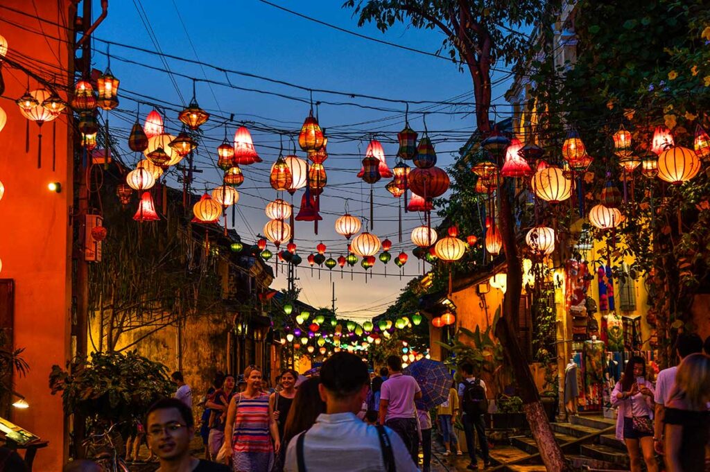 Lantern-lit Street in Hoi An: Vibrant lanterns of various colors illuminate a bustling street in Hoi An, creating a festive and enchanting scene.