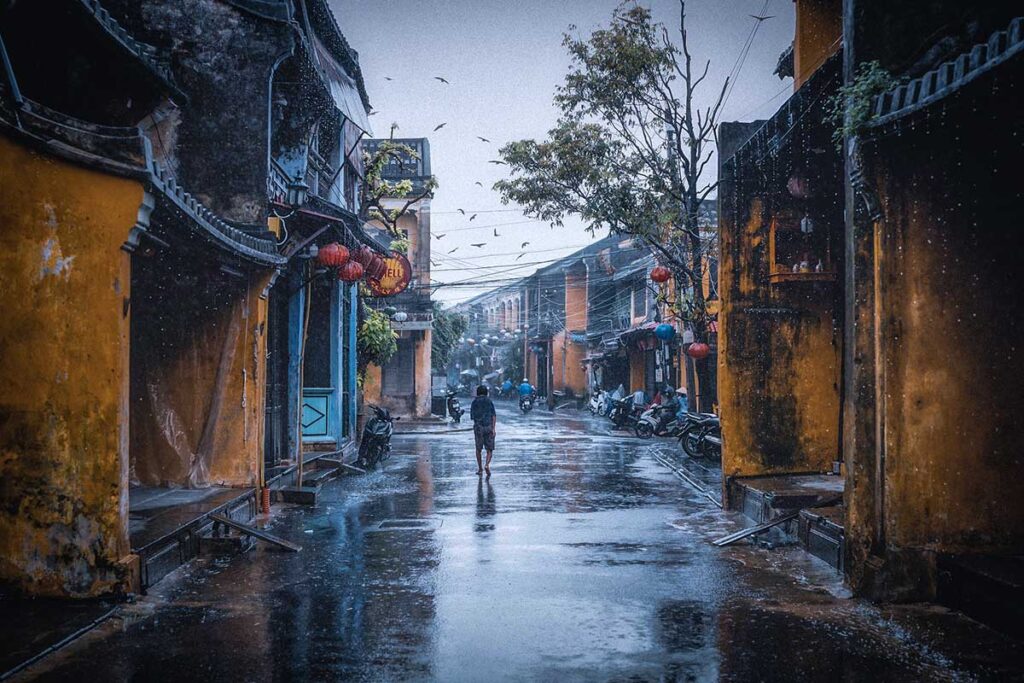 Rainy day in Hoi An ancient town, showcasing the charm of wet streets during Vietnam's rainy season.