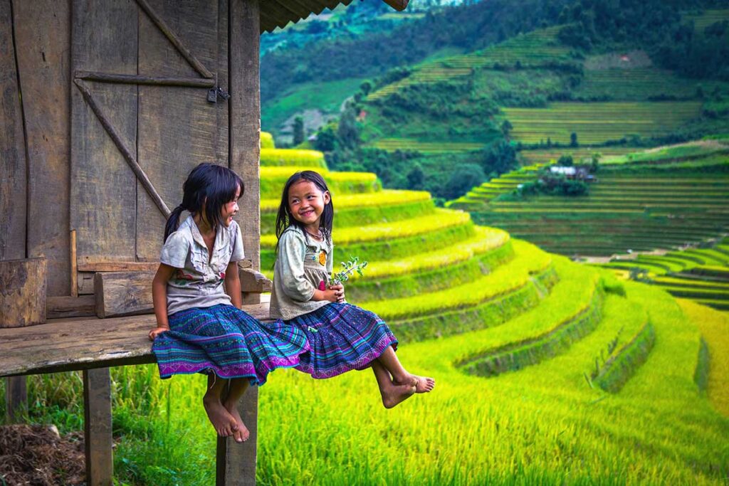 kids in Sapa sitting at a house overlooking stunning terraced rice fields