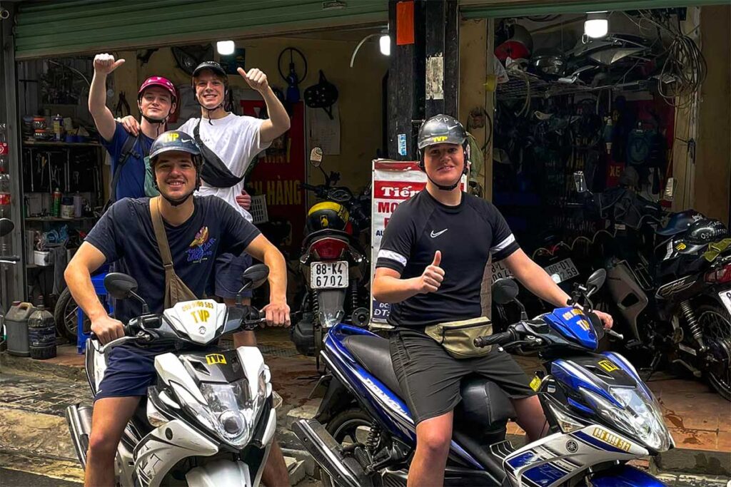 tourists renting motorbike scooters at a rental shop in Sapa