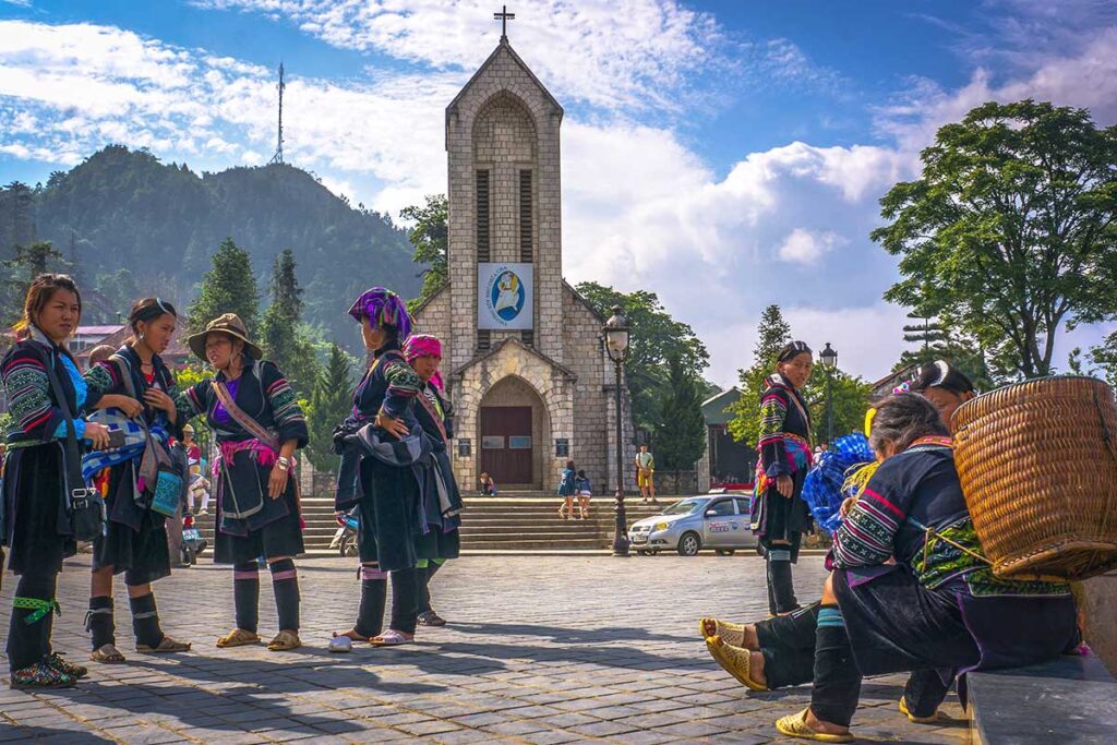 ethnic minority woman standing on the square in front of Sapa Stone Church