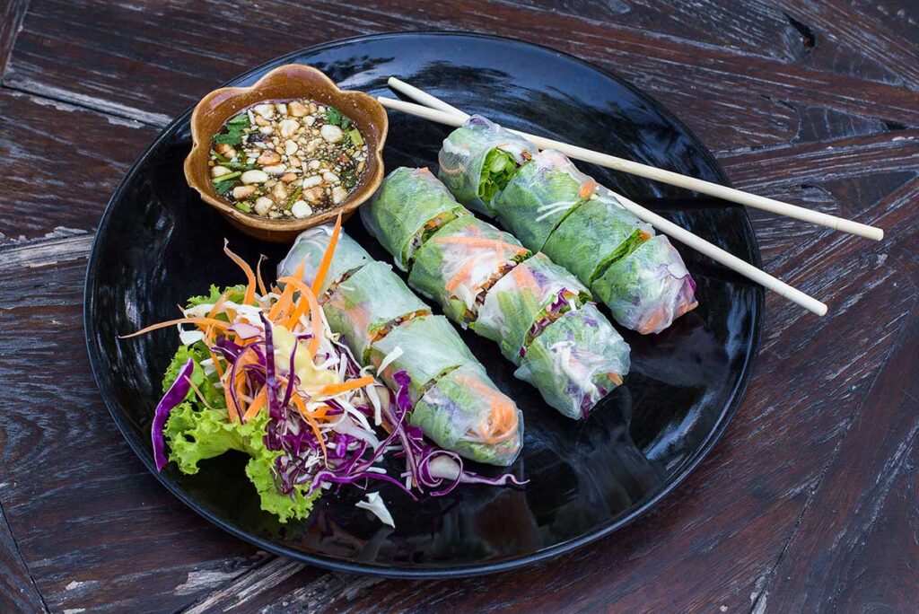 Vietnamese spring roll served with a dipping sauce made of peanuts, highlighting common food allergies.