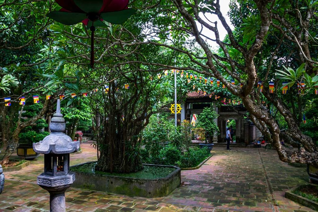 Tay Phuong Pagoda Inner Garden: Lush greenery and tranquil pathways create a peaceful atmosphere in the inner garden of Tay Phuong Pagoda near Hanoi.