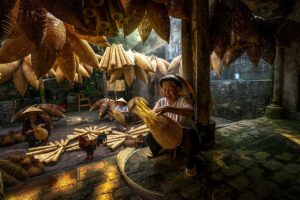 woman crafting fish traps at Thu Sy Village