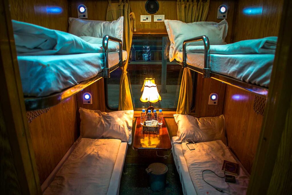 Interior of a well-maintained 4-berth cabin in a typical tourist sleeper train in Vietnam.