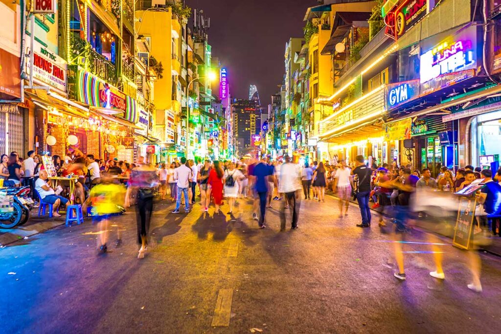 Vibrant Bui Vien Street in Vietnam, filled with backpackers and bustling bars.