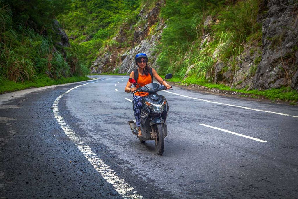 a foreign woman traveler in driving a motorbike in Vietnam