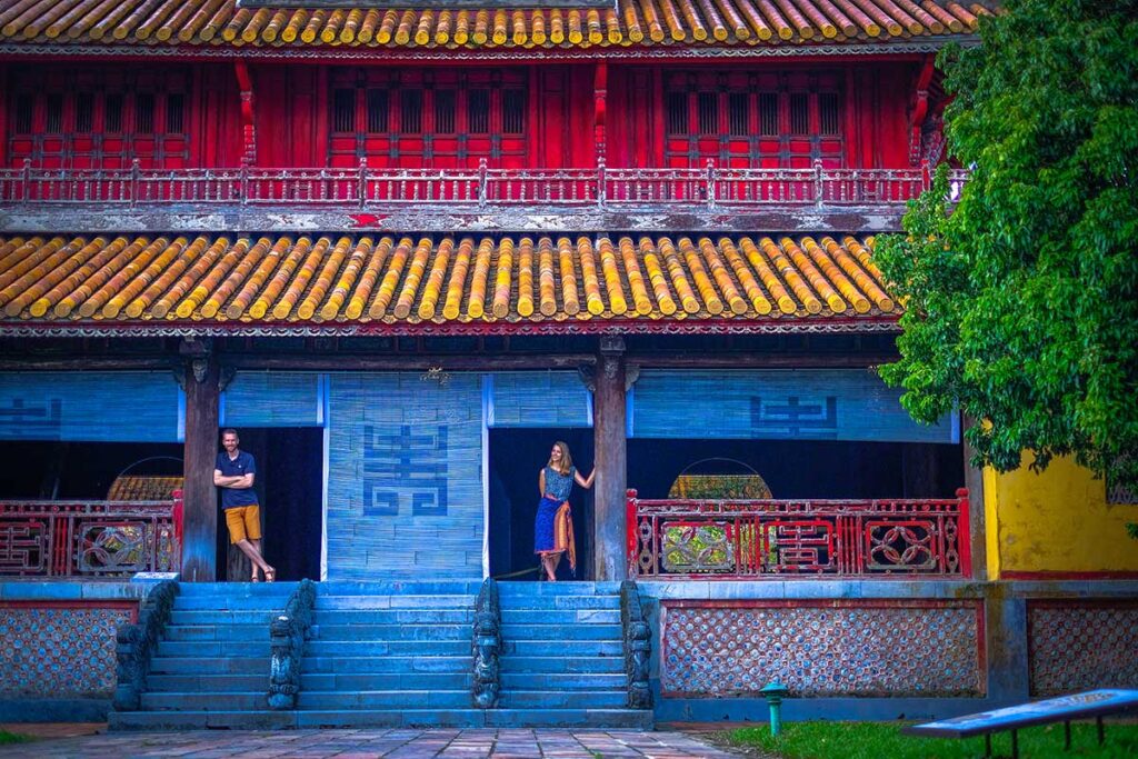 A couple standing in the door opening of a historical building inside Hue Imperial Citadel