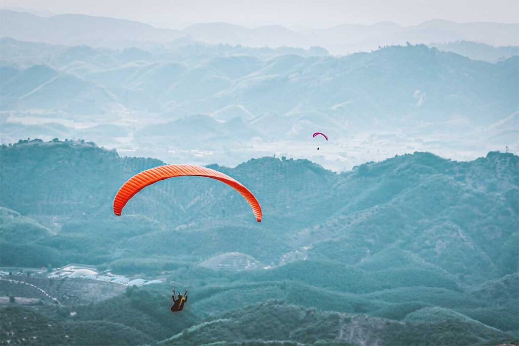 Paragliding over forests and hills near Dalat