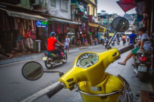 A yellow Vespa - Driving motorbike in Hanoi