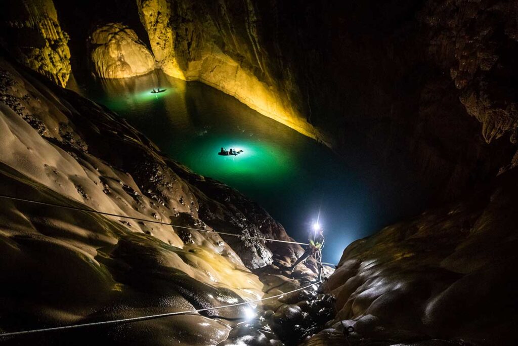 Travelers are abseiling and swimming inside Hang Son Doong Cave in Phong Nha National Park