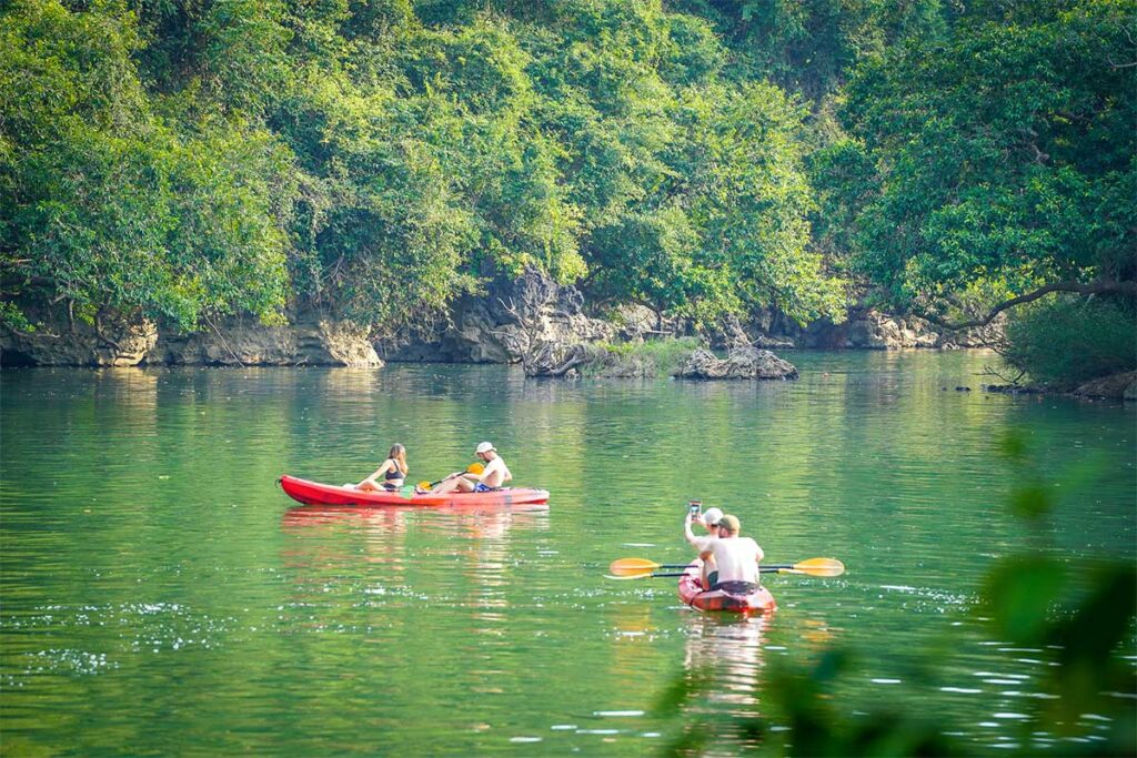 A tourist kayaking on Ba Be Lake