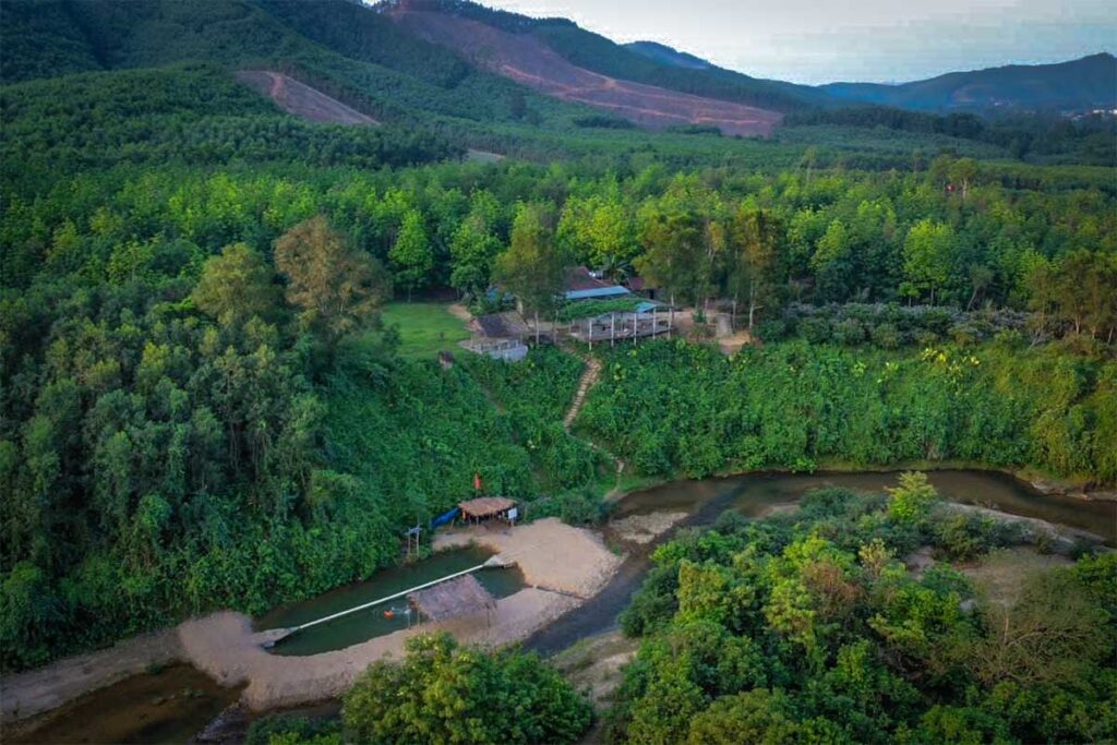 Aerial view of Cuong Rung Farm surrounded by forest and mountains