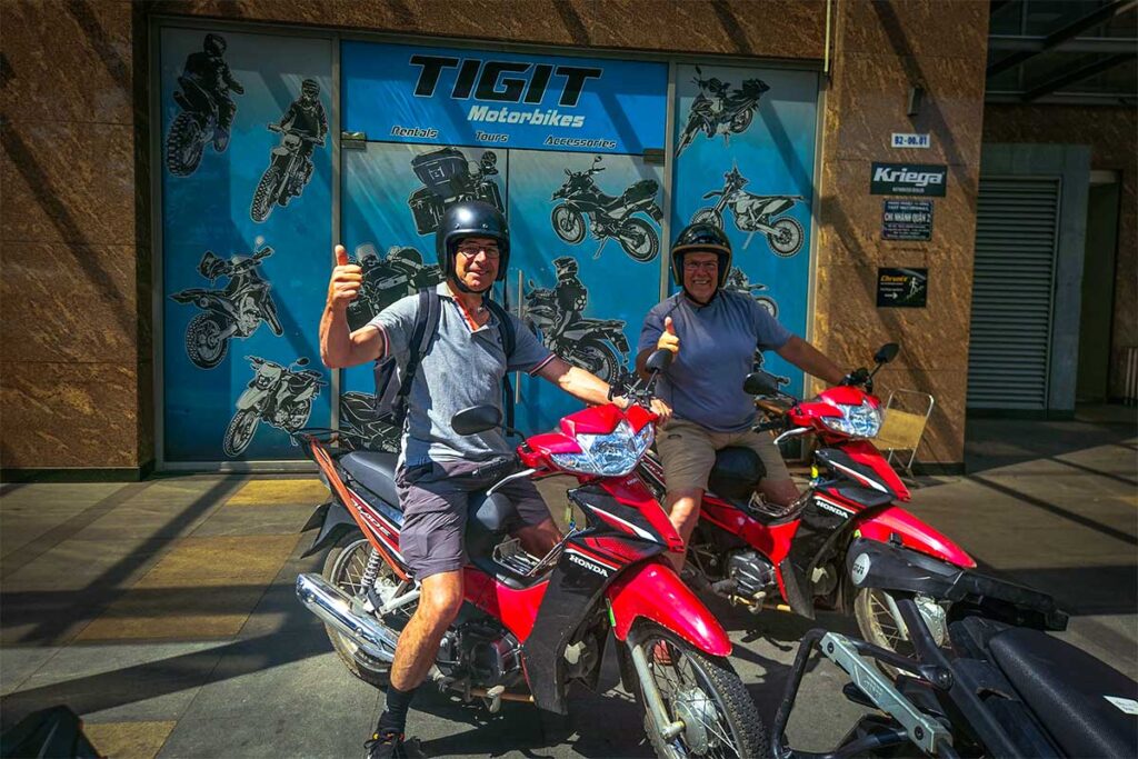 Two tourists on motorbikes rented from Tigit motorbike rental in Hanoi